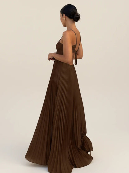 Maxi dress with a halter neckline and pleated A-line design, suitable for weddings. 1