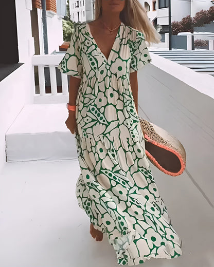 Maxi dress featuring a V-neckline and ruffles, designed for summer outings. 0