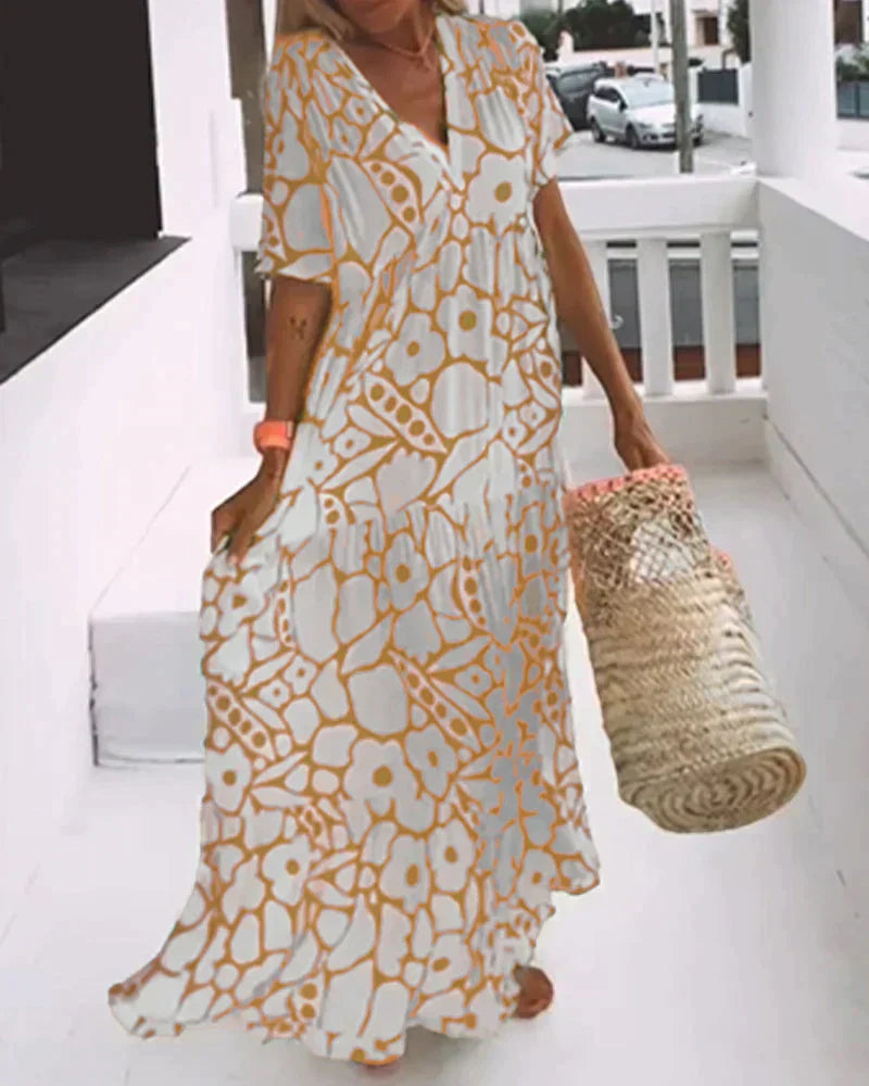 Maxi dress featuring a V-neckline and ruffles, designed for summer outings. 1