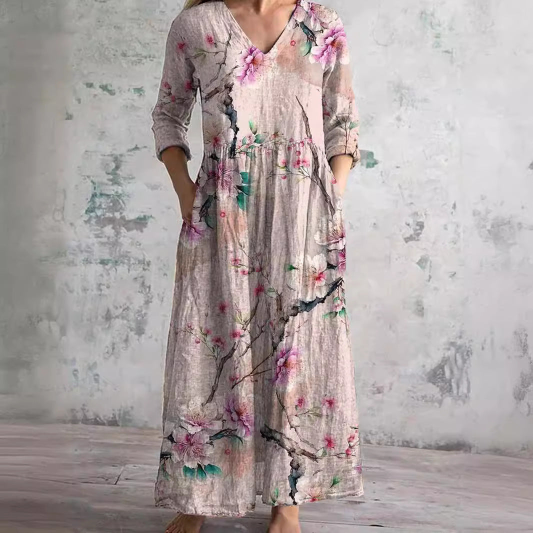 Maxi dress featuring a V-neckline and rolled sleeves, displayed on a mannequin against a neutral background. 1