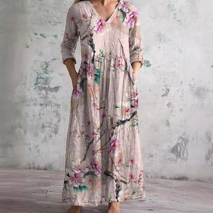 Maxi dress featuring a V-neckline and rolled sleeves, displayed on a mannequin against a neutral background. 1
