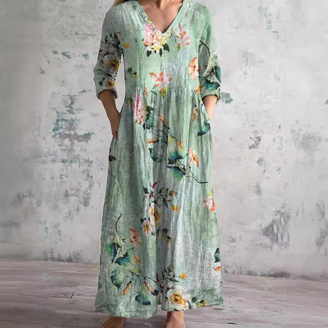 Maxi dress featuring a V-neckline and rolled sleeves, displayed on a mannequin against a neutral background. 2