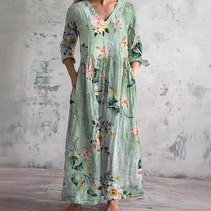 Maxi dress featuring a V-neckline and rolled sleeves, displayed on a mannequin against a neutral background. 2