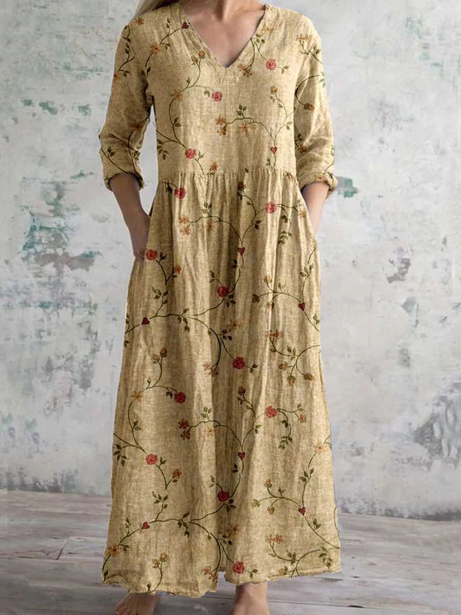 Maxi dress featuring a V-neckline and rolled sleeves, displayed on a mannequin against a neutral background. 4