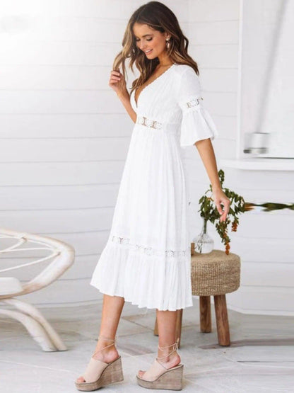 A midi dress featuring a V-neckline and an empire waist design, showcasing a flowing silhouette and a bohemian style. 3