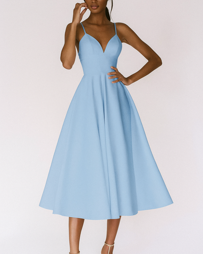 Dresses: A midi dress with spaghetti straps featuring an elegant accent, designed for formal occasions like weddings. 4
