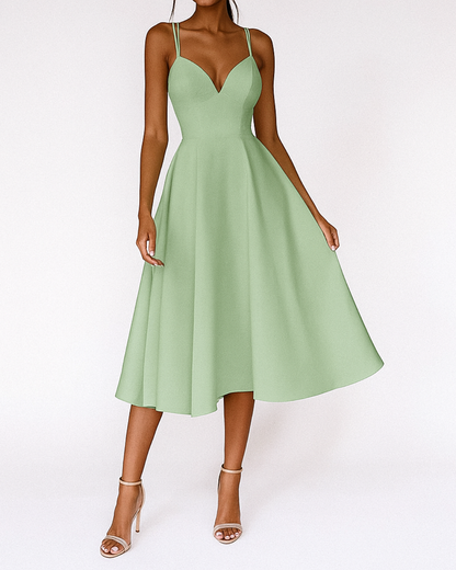 Dresses: A midi dress with spaghetti straps featuring an elegant accent, designed for formal occasions like weddings. 5