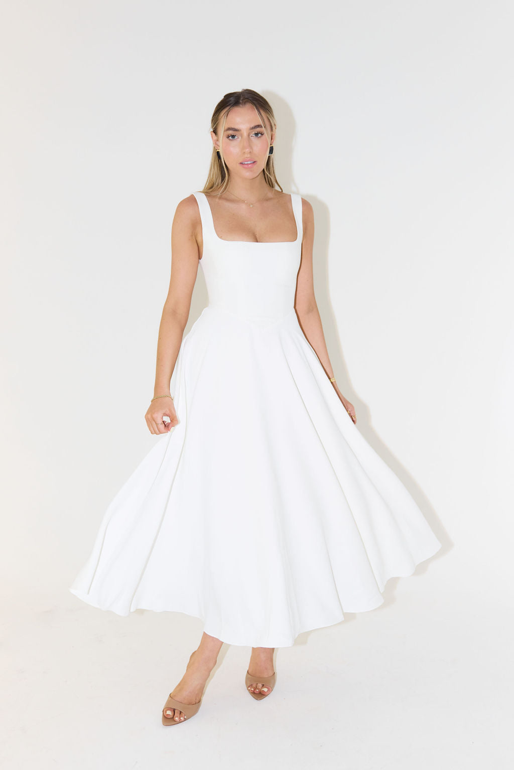 A midi dress for women featuring a fitted waist and a pleated skirt, designed for formal occasions like weddings. 1