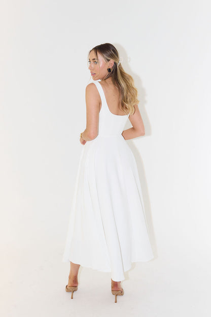 A midi dress for women featuring a fitted waist and a pleated skirt, designed for formal occasions like weddings. 4