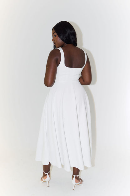A midi dress for women featuring a fitted waist and a pleated skirt, designed for formal occasions like weddings. 5