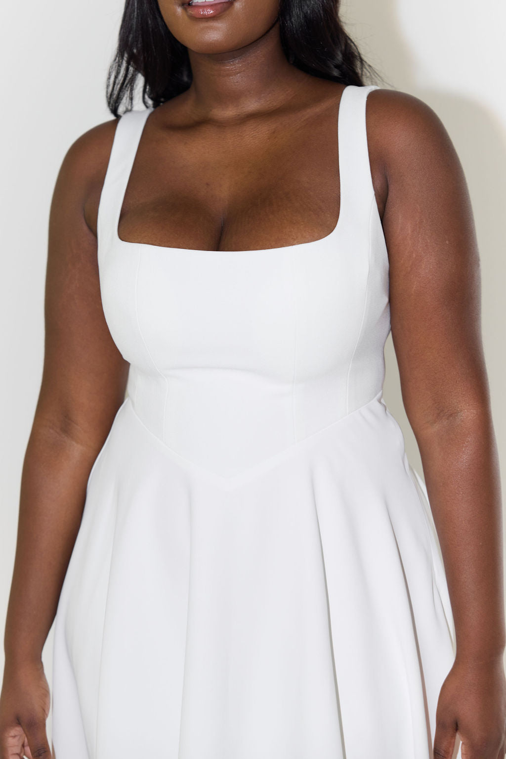 A midi dress for women featuring a fitted waist and a pleated skirt, designed for formal occasions like weddings. 6
