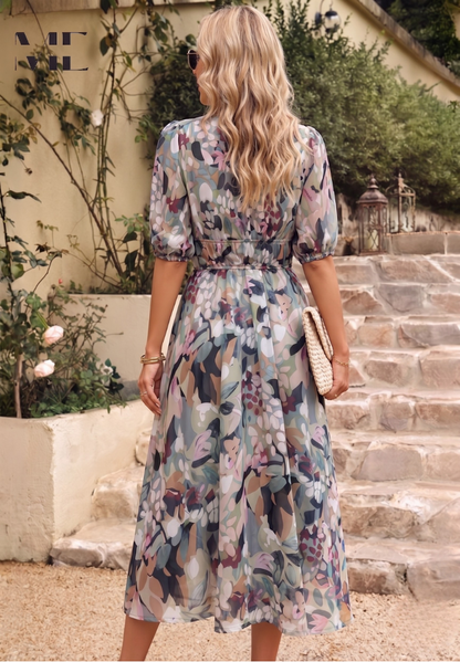 Midi dress featuring a floral print and puff sleeves. 1