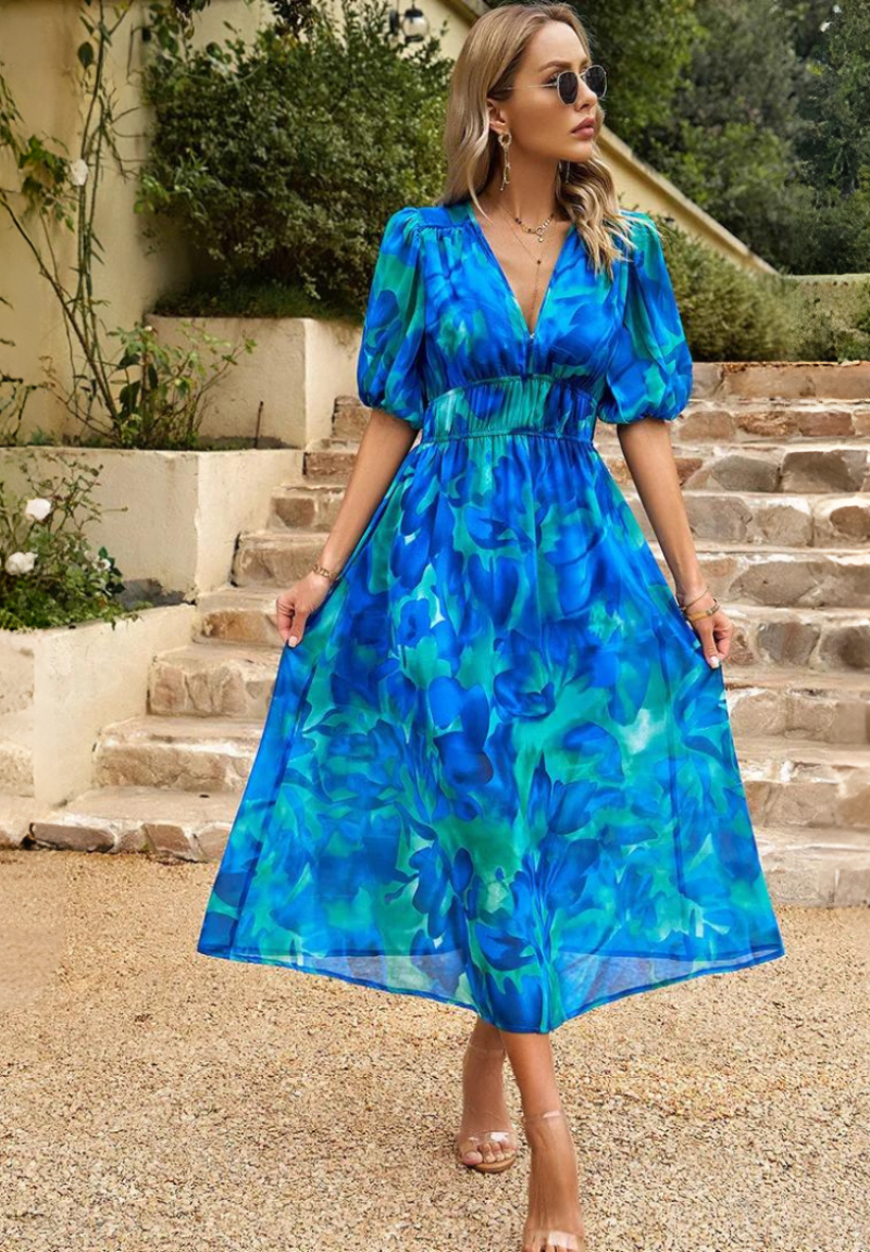 Midi dress featuring a floral print and puff sleeves. 2