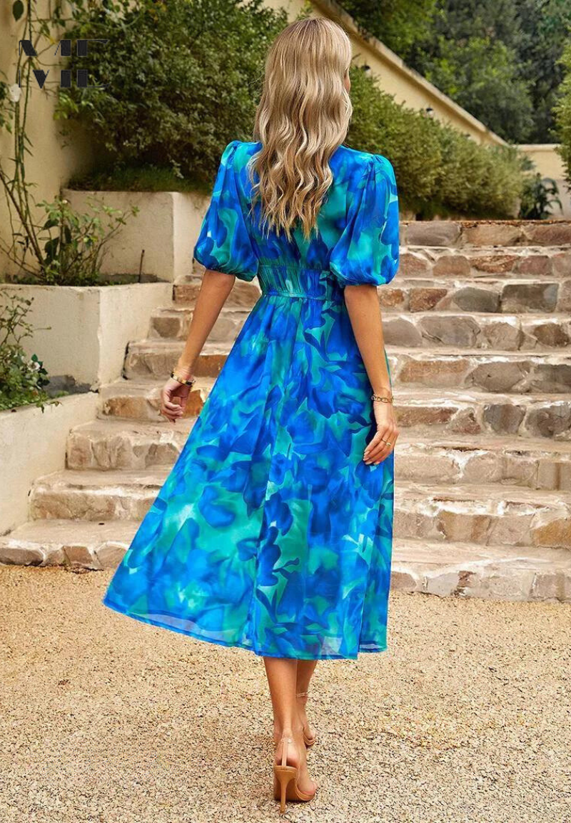 Midi dress featuring a floral print and puff sleeves. 3