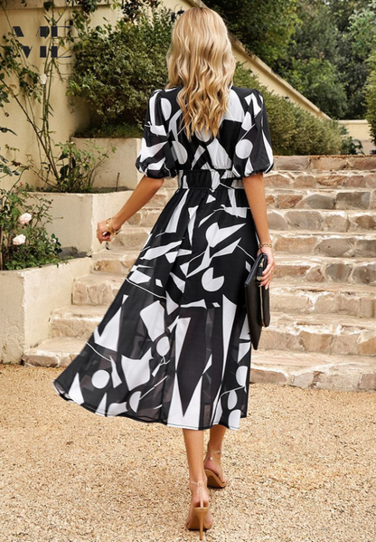 Midi dress featuring a floral print and puff sleeves. 8