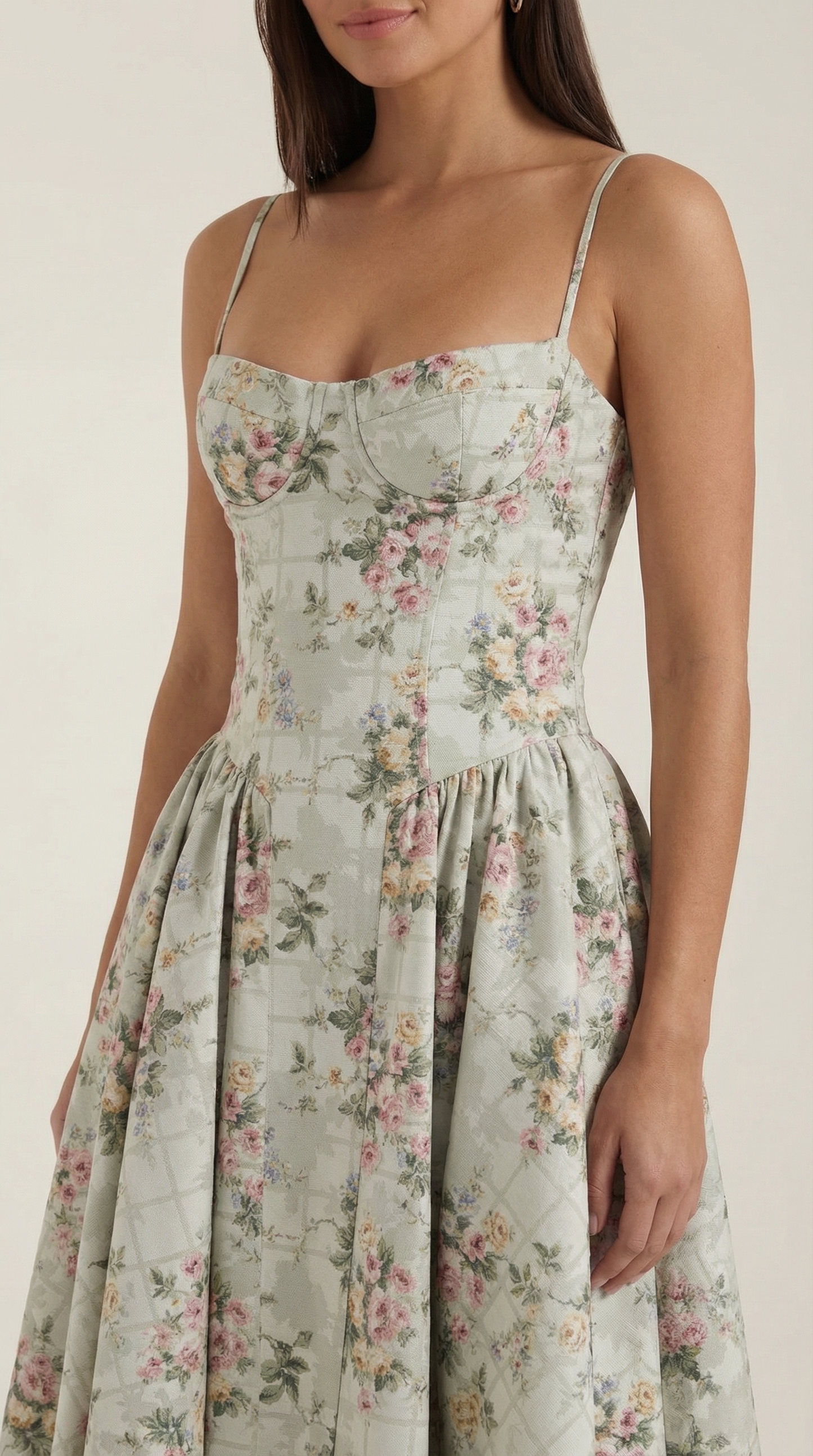 A midi dress featuring a floral print and a corset-style belt, designed for women's formal events such as weddings and summer celebrations. 2