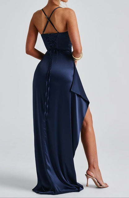 Maxi evening dress with straps featuring a high slit, designed for women. The dress falls to the floor and showcases a sleek silhouette. 1