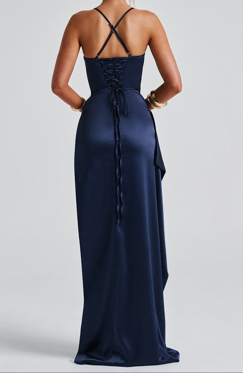 Maxi evening dress with straps featuring a high slit, designed for women. The dress falls to the floor and showcases a sleek silhouette. 3