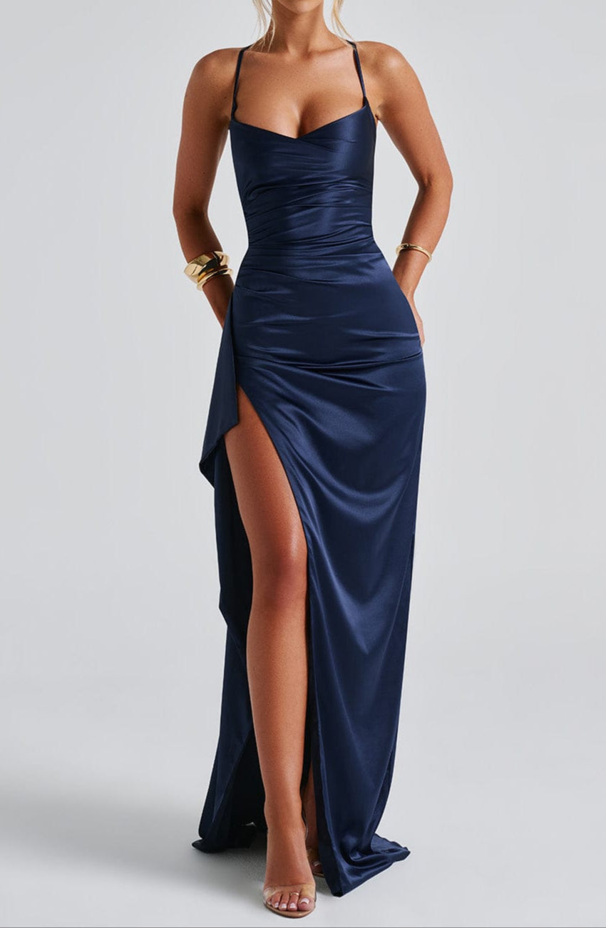 Maxi evening dress with straps featuring a high slit, designed for women. The dress falls to the floor and showcases a sleek silhouette. 4