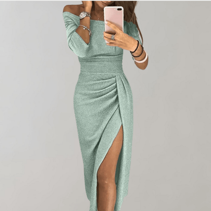A woman wearing a sleeveless evening dress with off-the-shoulder design and a thigh-high slit, standing in a neutral setting. 2