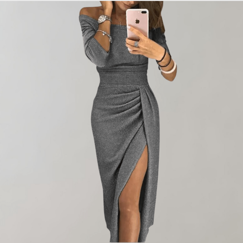 A woman wearing a sleeveless evening dress with off-the-shoulder design and a thigh-high slit, standing in a neutral setting. 4