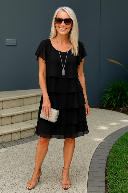 A women's midi dress with short sleeves, featuring a layered design and a flowing silhouette. 5