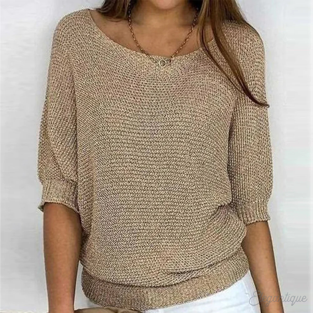 Loose women's sweater with a round neckline, featuring a relaxed fit and long sleeves, displayed on a neutral background. 0