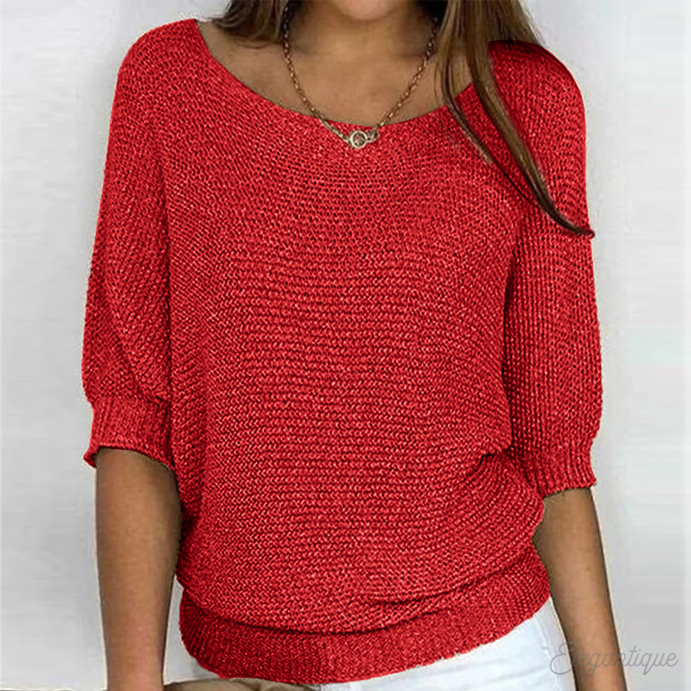 Loose women's sweater with a round neckline, featuring a relaxed fit and long sleeves, displayed on a neutral background. 1