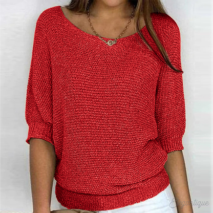 Loose women's sweater with a round neckline, featuring a relaxed fit and long sleeves, displayed on a neutral background. 1