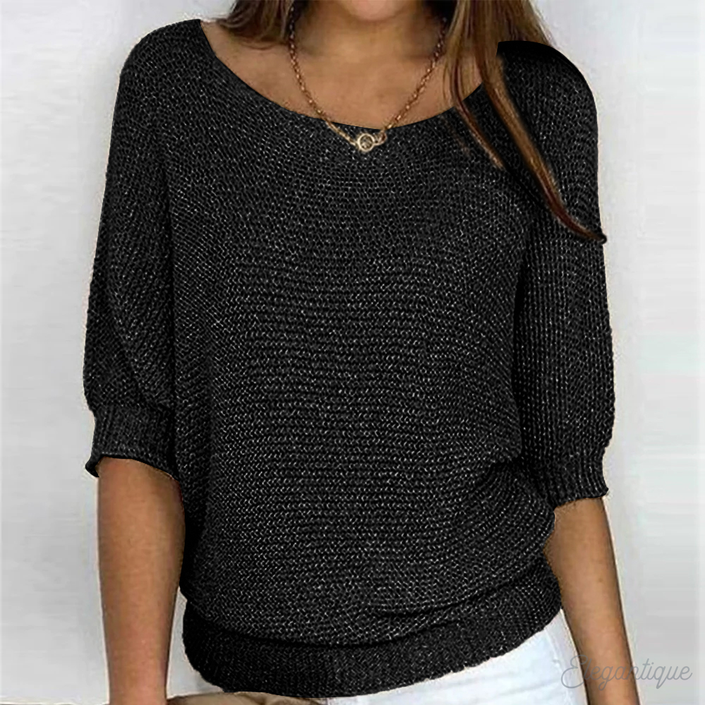 Loose women's sweater with a round neckline, featuring a relaxed fit and long sleeves, displayed on a neutral background. 2