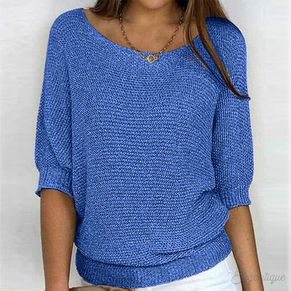 Loose women's sweater with a round neckline, featuring a relaxed fit and long sleeves, displayed on a neutral background. 3