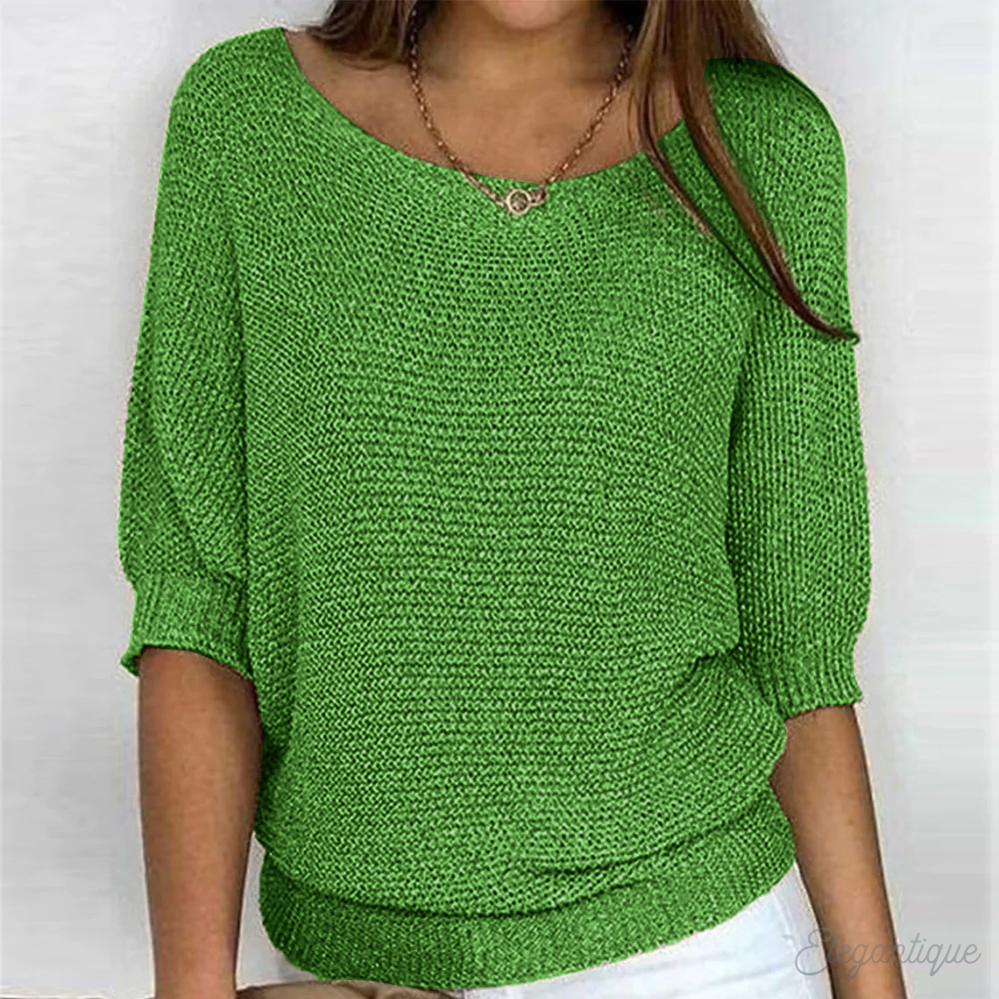 Loose women's sweater with a round neckline, featuring a relaxed fit and long sleeves, displayed on a neutral background. 5