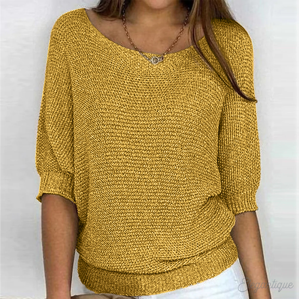 Loose women's sweater with a round neckline, featuring a relaxed fit and long sleeves, displayed on a neutral background. 6