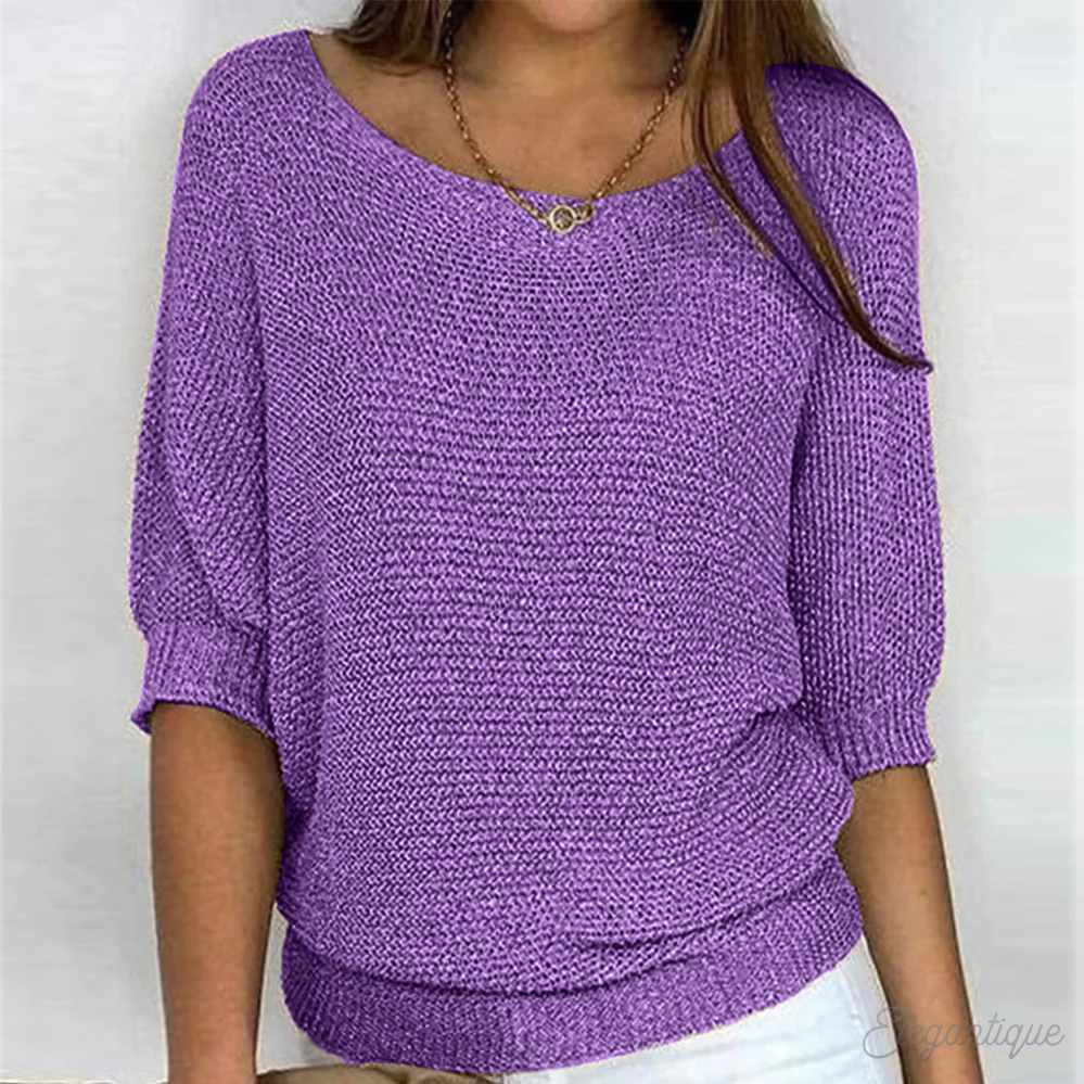 Loose women's sweater with a round neckline, featuring a relaxed fit and long sleeves, displayed on a neutral background. 7