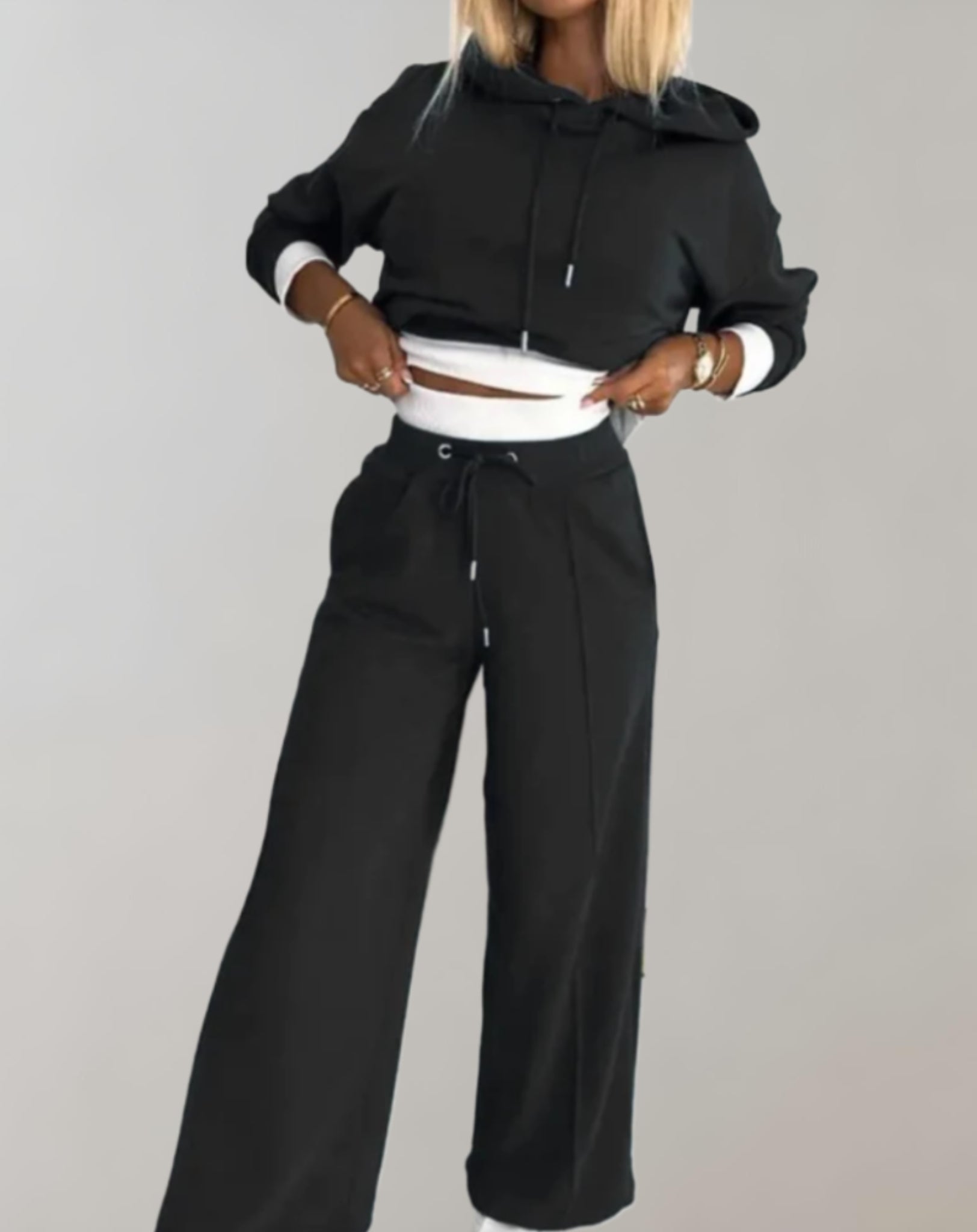 Women's recreational set featuring a hooded top and jogger pants. The outfit is displayed on a neutral background, showcasing the comfortable fit and casual style. 0