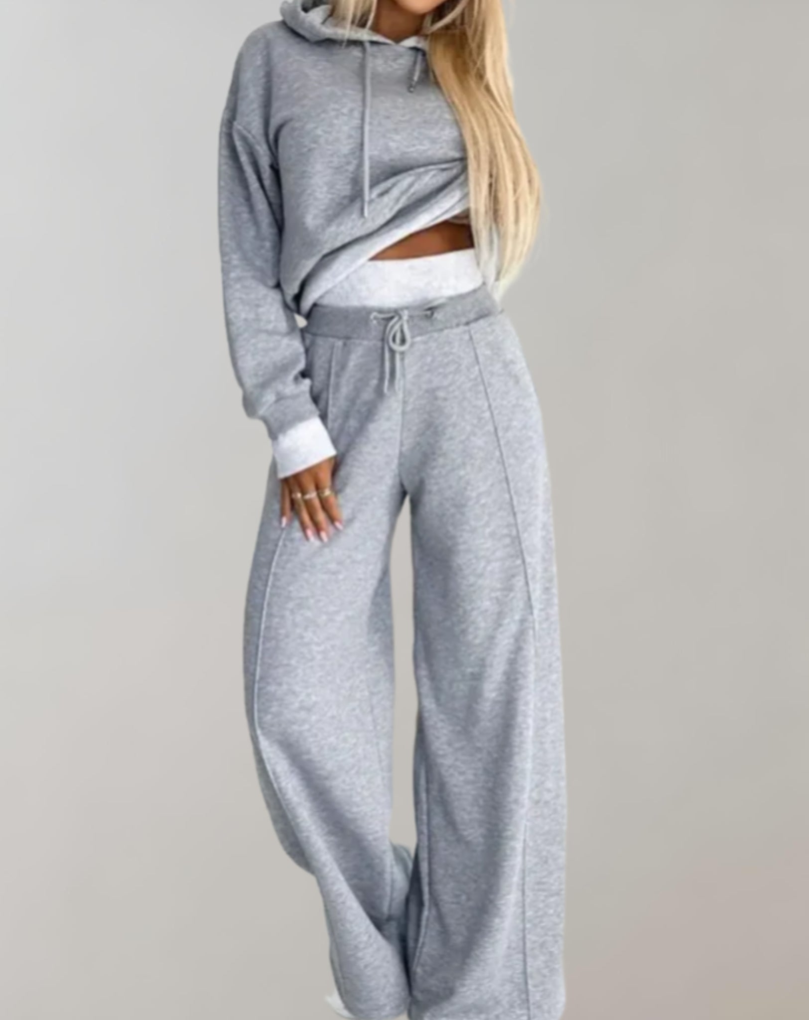 Women's recreational set featuring a hooded top and jogger pants. The outfit is displayed on a neutral background, showcasing the comfortable fit and casual style. 2