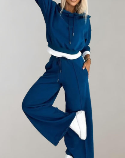 Women's recreational set featuring a hooded top and jogger pants. The outfit is displayed on a neutral background, showcasing the comfortable fit and casual style. 3