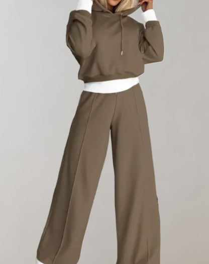 Women's recreational set featuring a hooded top and jogger pants. The outfit is displayed on a neutral background, showcasing the comfortable fit and casual style. 4