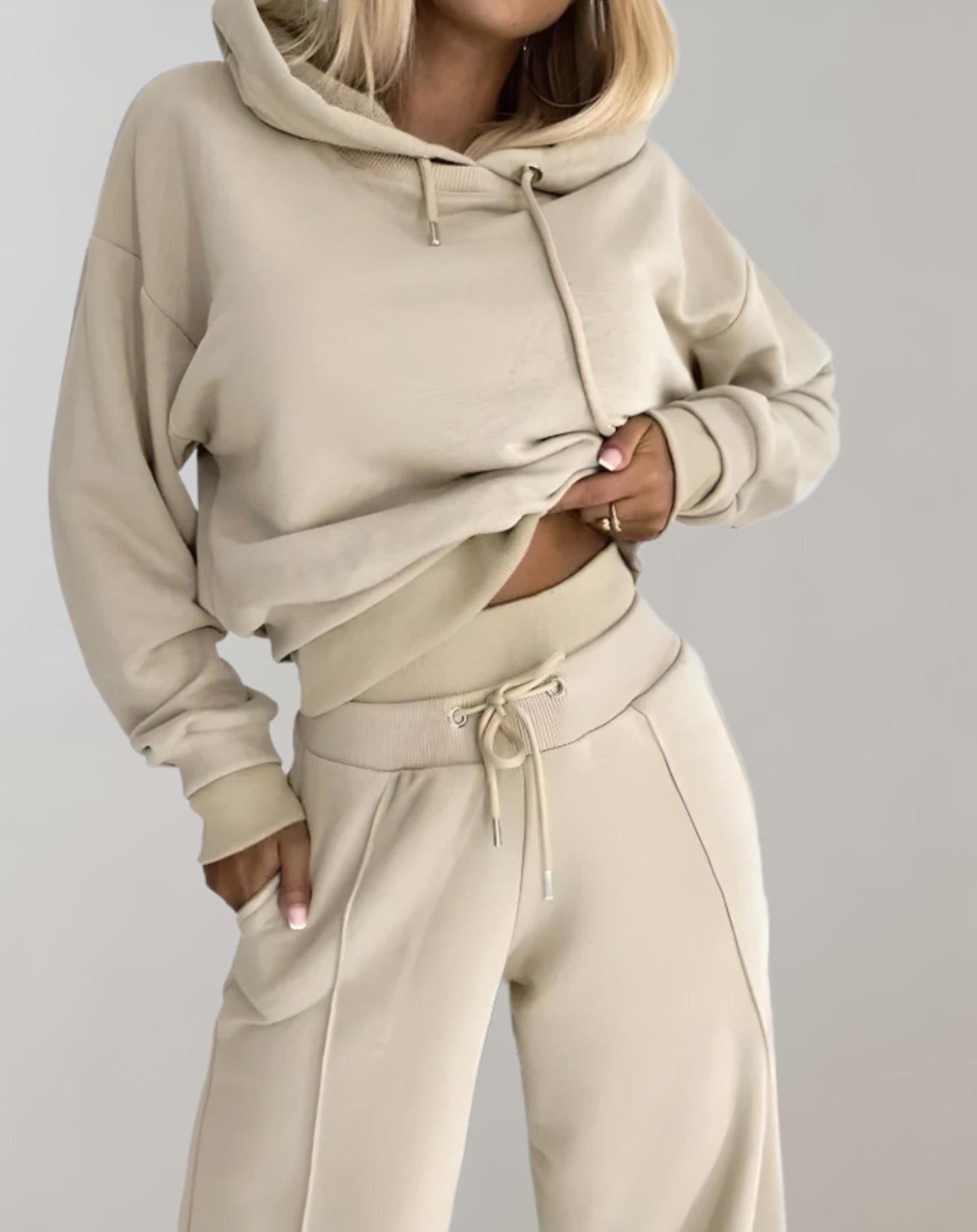 Women's recreational set featuring a hooded top and jogger pants. The outfit is displayed on a neutral background, showcasing the comfortable fit and casual style. 5