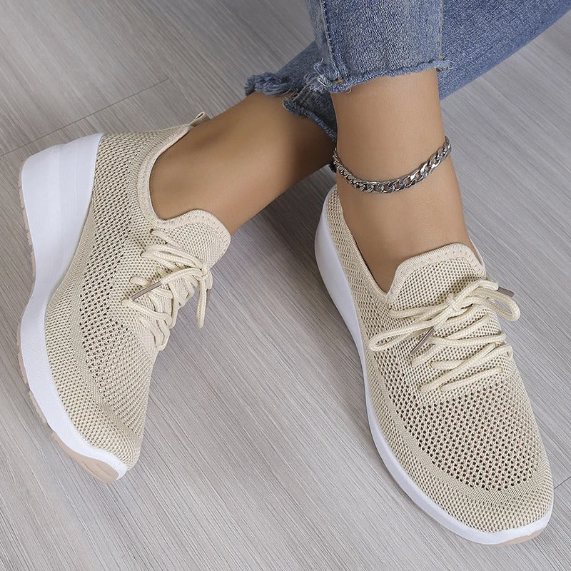 Women's athletic shoes featuring a mesh upper and a non-slip sole. 1