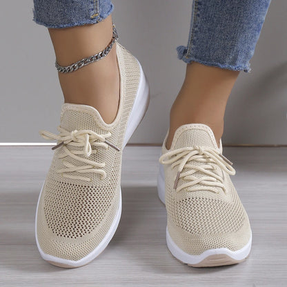 Women's athletic shoes featuring a mesh upper and a non-slip sole. 2