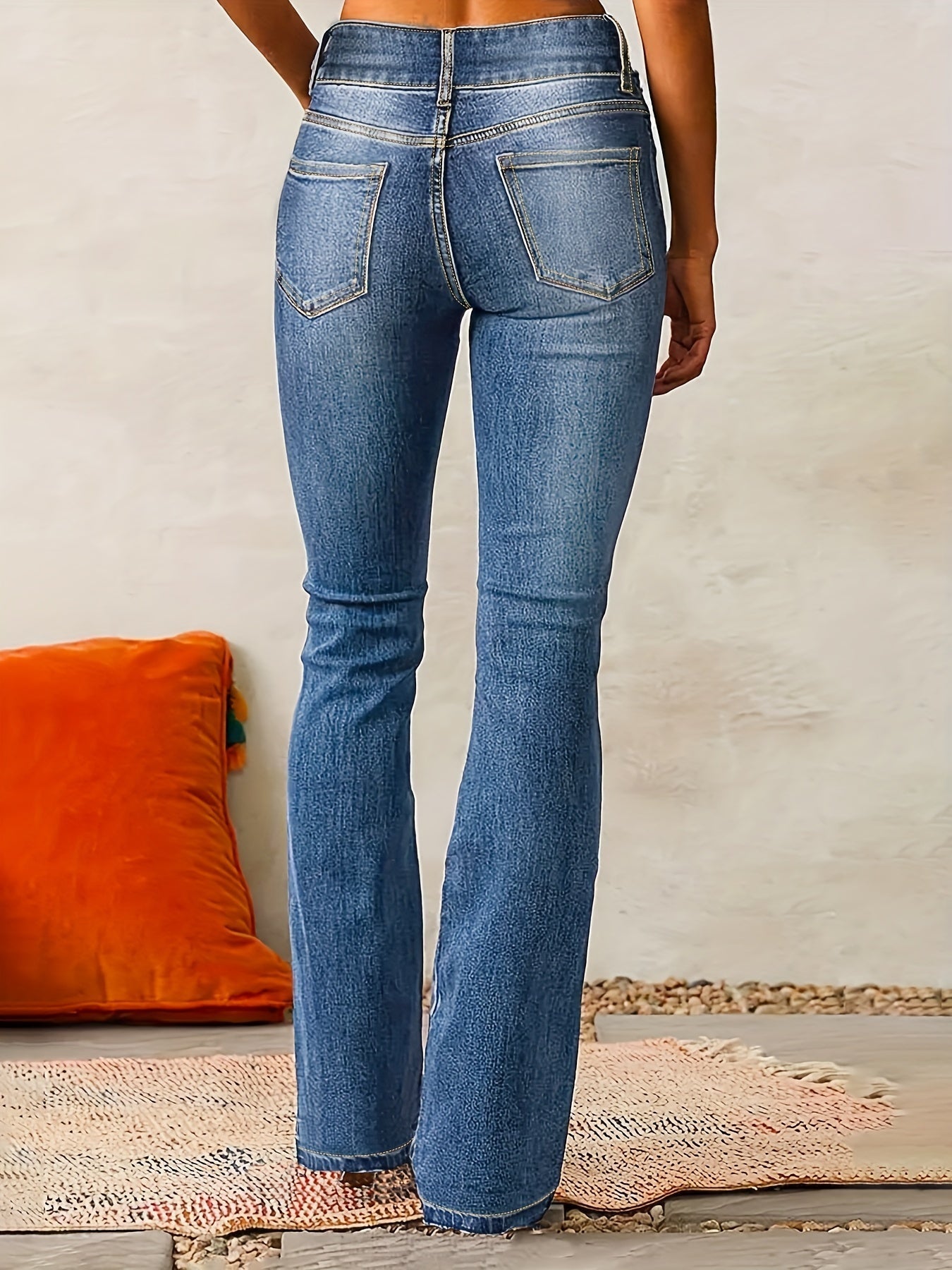 Woman's high-waisted black jeans with wide legs displayed on a plain background. 1