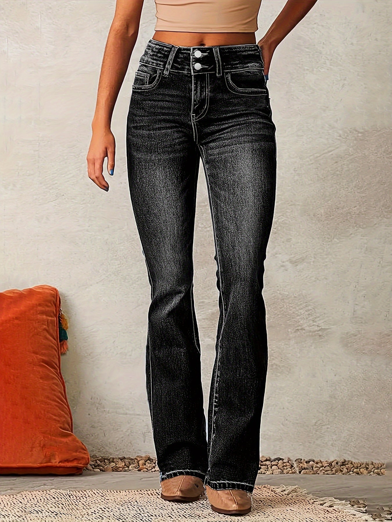 Woman's high-waisted black jeans with wide legs displayed on a plain background. 2