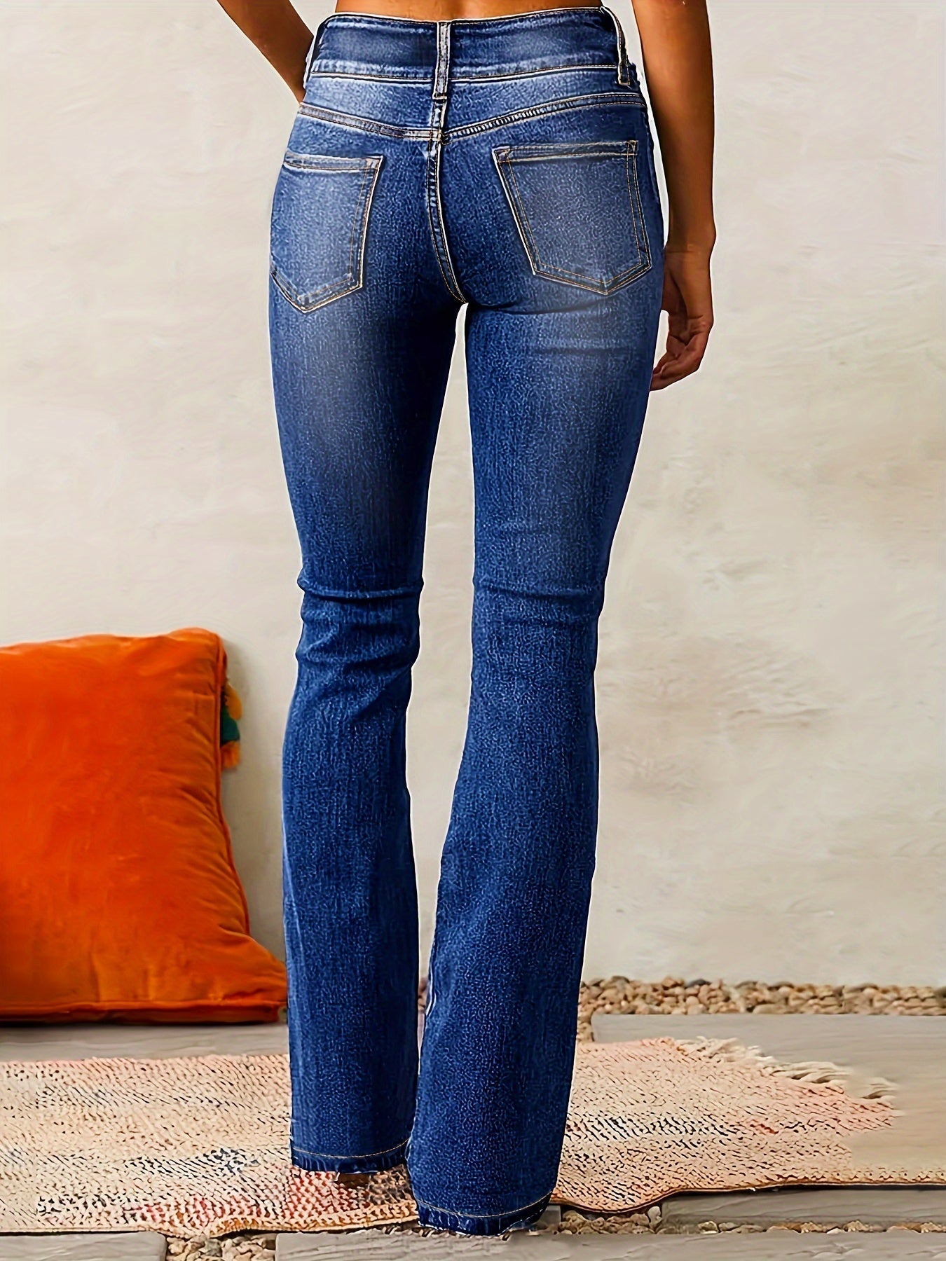 Woman's high-waisted black jeans with wide legs displayed on a plain background. 4