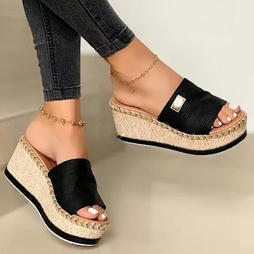 Women's wedge espadrilles featuring a woven sole and a wide strap. 1
