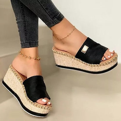 Women's wedge espadrilles featuring a woven sole and a wide strap. 1