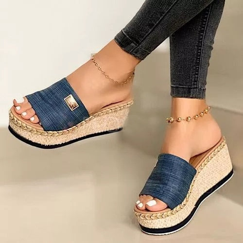 Women's wedge espadrilles featuring a woven sole and a wide strap. 4