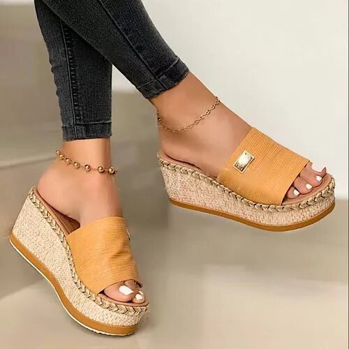 Women's wedge espadrilles featuring a woven sole and a wide strap. 5
