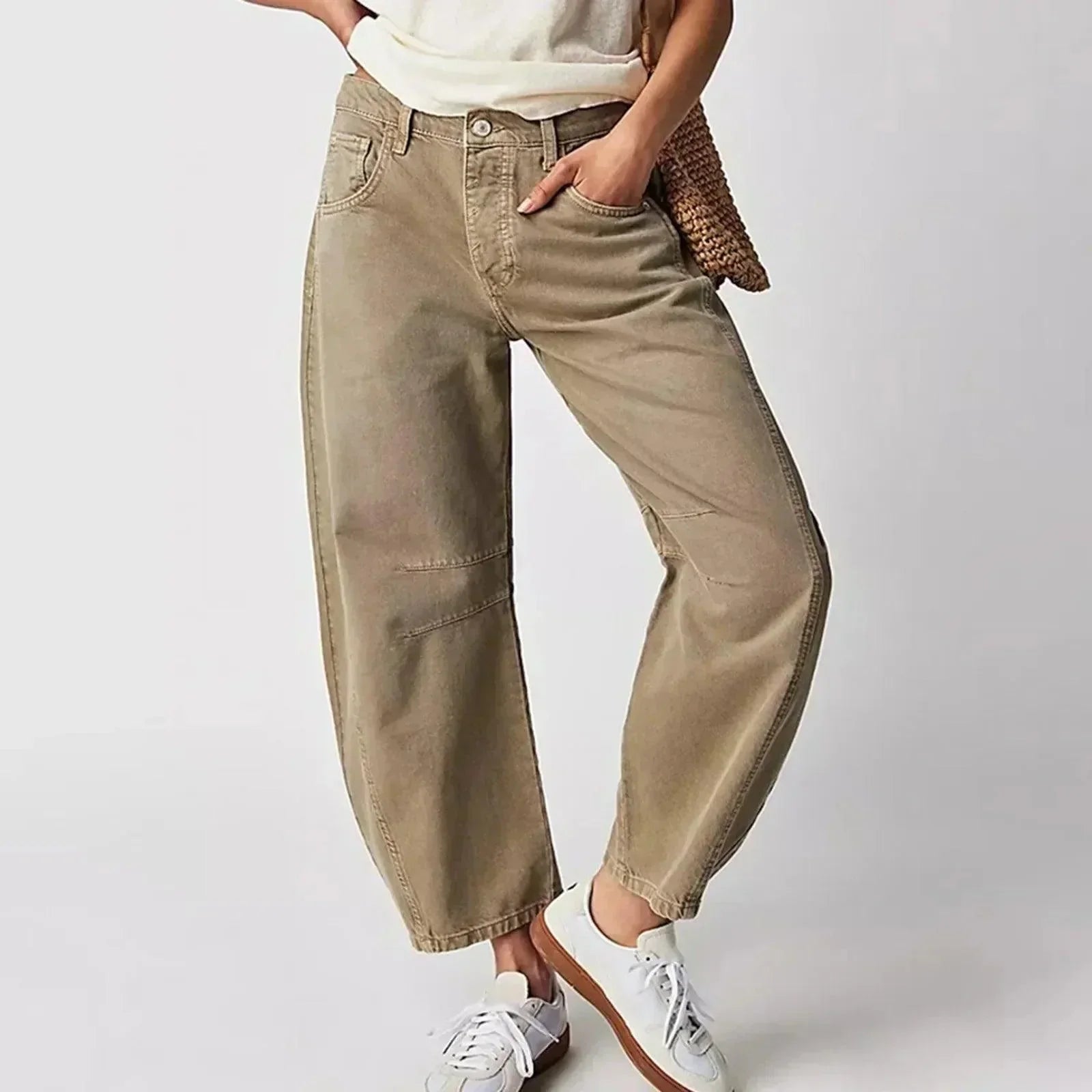 Loose high-waisted women's jeans displayed on a flat surface, featuring a relaxed fit and a classic five-pocket design. 0