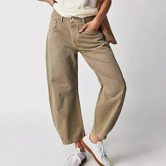 Loose high-waisted women's jeans displayed on a flat surface, featuring a relaxed fit and a classic five-pocket design. 0